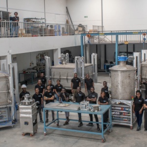Members of the Octavia Carbon team posing with some of the DAC machines they have helped develop.