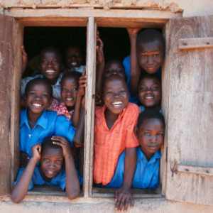 children smiling and sticking heads out window