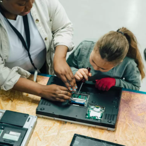 Students taking apart a laptop computer