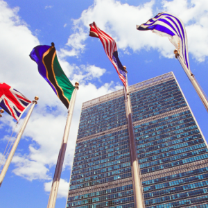 upward view of flags in front of the UN building