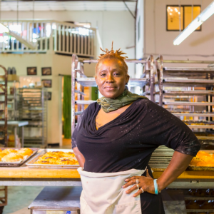 a baker standing in a bakery