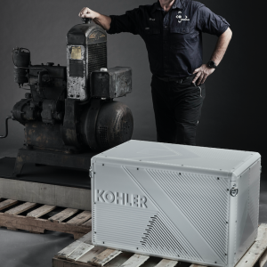 Robert Swan standing behind Kohler-branded engine