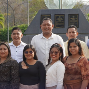 A group of young men and women pose outdoors for a group photo after completing DP World’s Comienza con Nosotros technical training program.