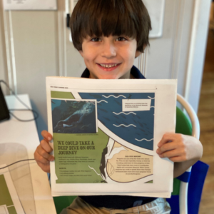 Boy holding up a learning guide