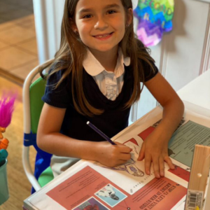 Girl coloring in her guide