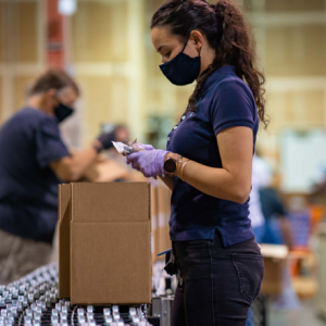 Person packing food in assembly line