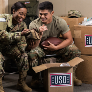 Two soldiers opening USO package