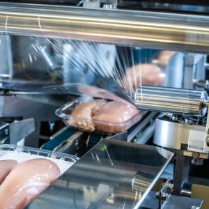 food products being covered with film wrap. 