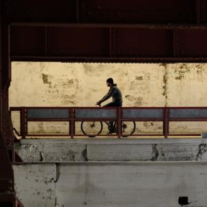 Richard McMichael riding a bike in an industrial landscape
