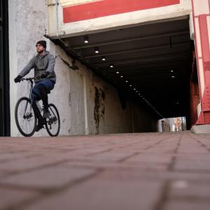 Richard McMichael riding his bike through a city
