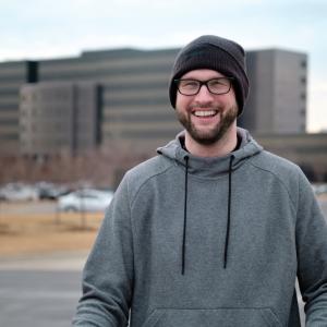 Richard McMichael in a hat and glasses, smiling