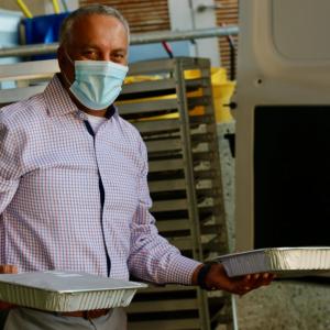 person holding packaged meals