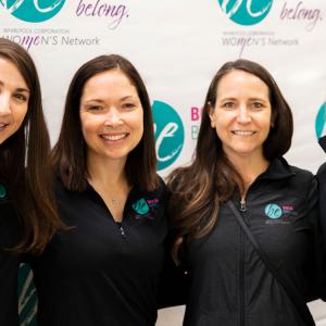 a group of 4 people including Lynn Moersch wearing matching jackets with "Be" logo