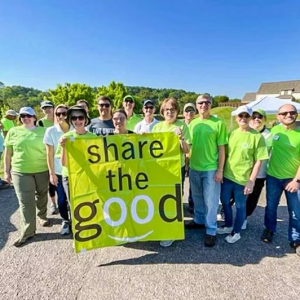 Volunteers with a share the good banner