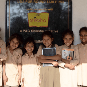 school girls in front of sign