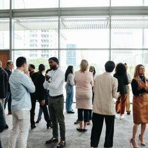 Corporate crowd engaging in teamwork during business event in modern office space