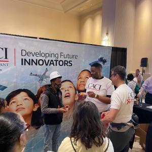 Three people demonstrate an experiment for onlookers.