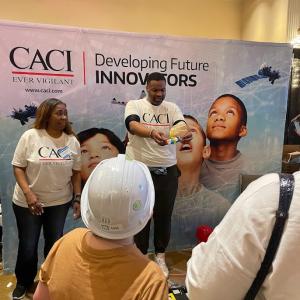 Two CACI presenters doing an experiment for others.