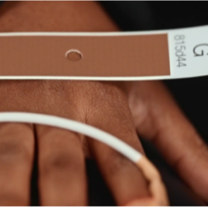 Image of a hand overlaid with a strip of paper matching the individual's skin tone