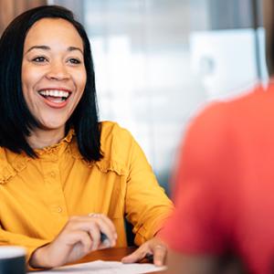 Female business owner shown speaking with an associate.