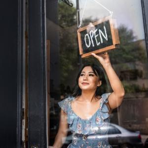 Small business owner shown opening her business.