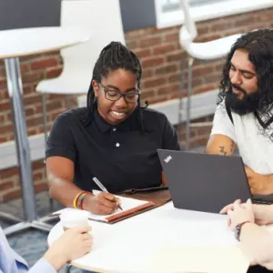 Group of people sat around a table 