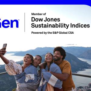 A group posed for a selfie, a mountain landscape in the background.