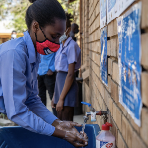 Schoolchildren using outdoor handwashing facilities at Ramauba Secondary School in the northwest part of the country. 