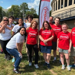 People standing on lawn in Henkel t-shirts