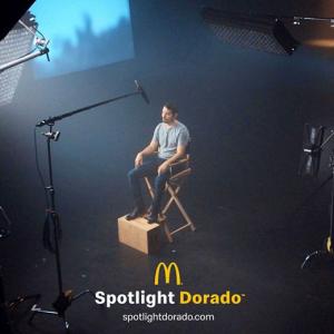 Person sat on a film set under a spotlight