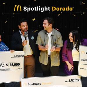 McDonalds logo and "Spotlight Dorado" above three award recipients and presenters holding large checks as confetti falls.