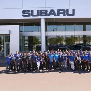 Group in front of a Subaru building