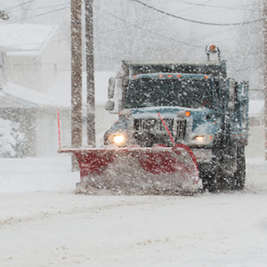 Plows clearing snow during a severe storm.
