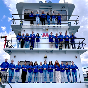 group of people lined up on a boat