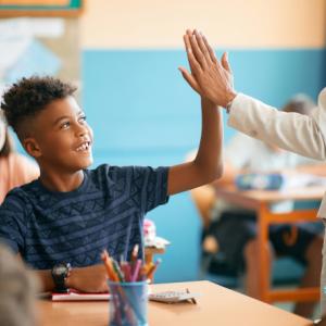 teacher high-fiving student