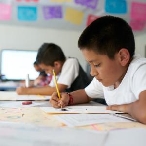 students writing in classroom