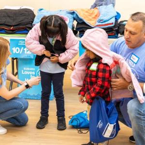 Children trying on jackets