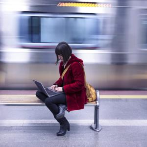 a person in a subway station working on a laptop