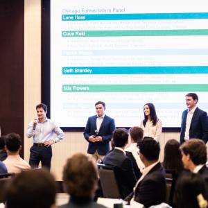 group of interns standing in front of room