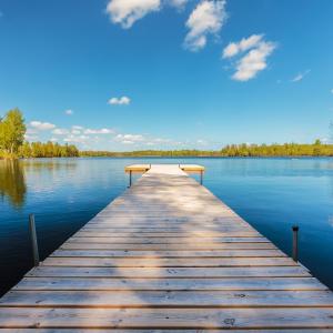 landscape photograph of a dock stretching out into a lake