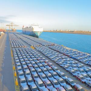 Rows of cars at port, ready to be shipped