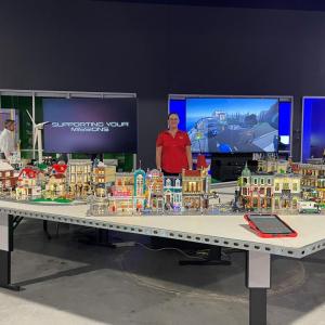 Kimberly Childers standing in front of lego booth