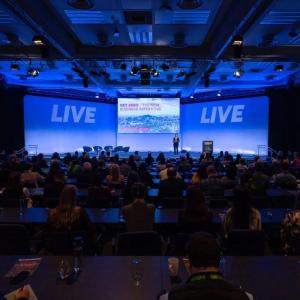 A person on stage in front of an audience 