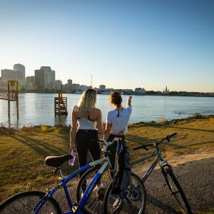 Two people looking at cityscape with bikes next to them