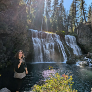 Bliss Buter-Thompson standing outside near a waterfall