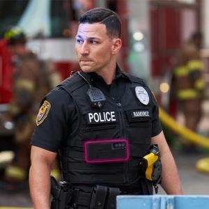 Policeman standing near firefighters on a city street