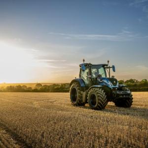 tractor on a field at dawn