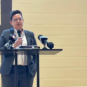 Speaker addressing the group at the ribbon cutting ceremony.