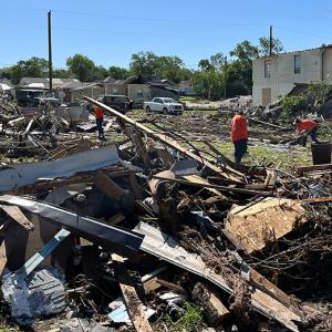 The Home Depot Foundation volunteers shown working through tornado damage in a community. 