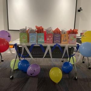 table full of activity kit bags with balloons